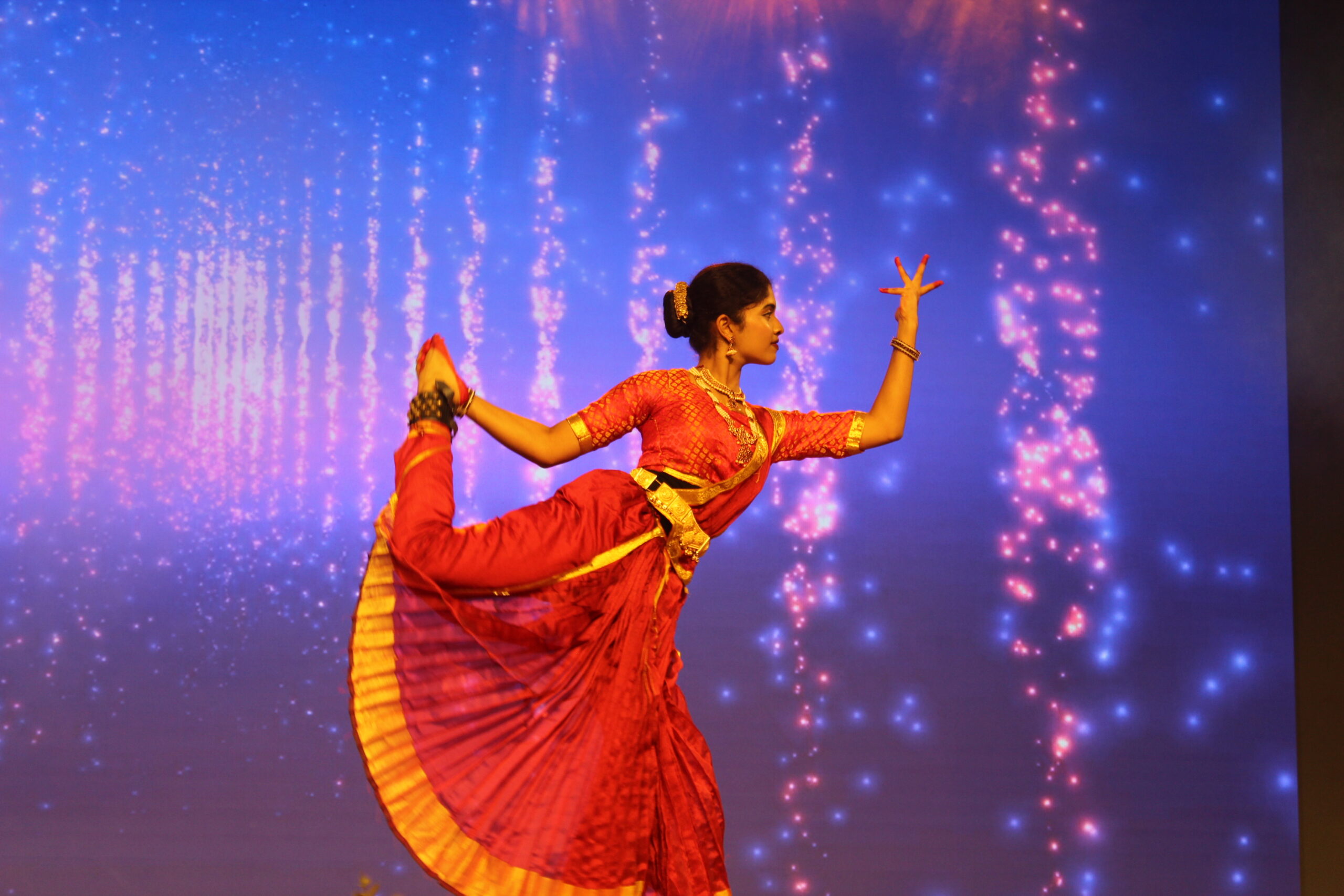 Students and staff performing during Novato Fiesta 2K25 Freshers' Day celebration at De Paul International Residential School, Mysuru.