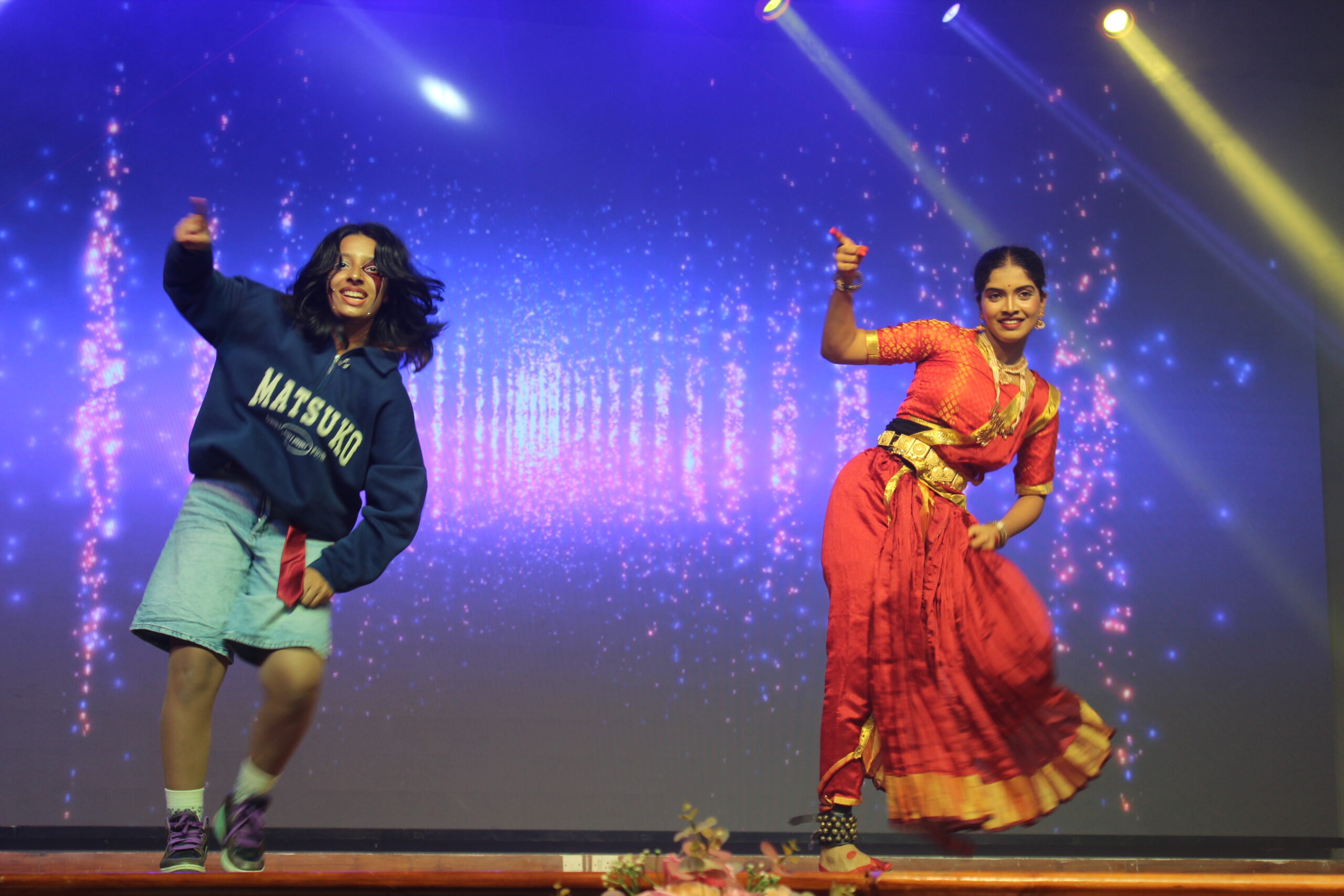 Students and staff performing during Novato Fiesta 2K25 Freshers' Day celebration at De Paul International Residential School, Mysuru.