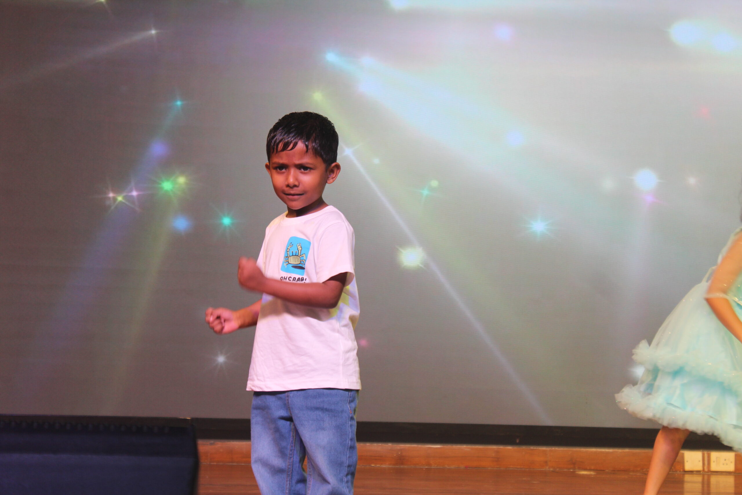 Students and staff performing during Novato Fiesta 2K25 Freshers' Day celebration at De Paul International Residential School, Mysuru.