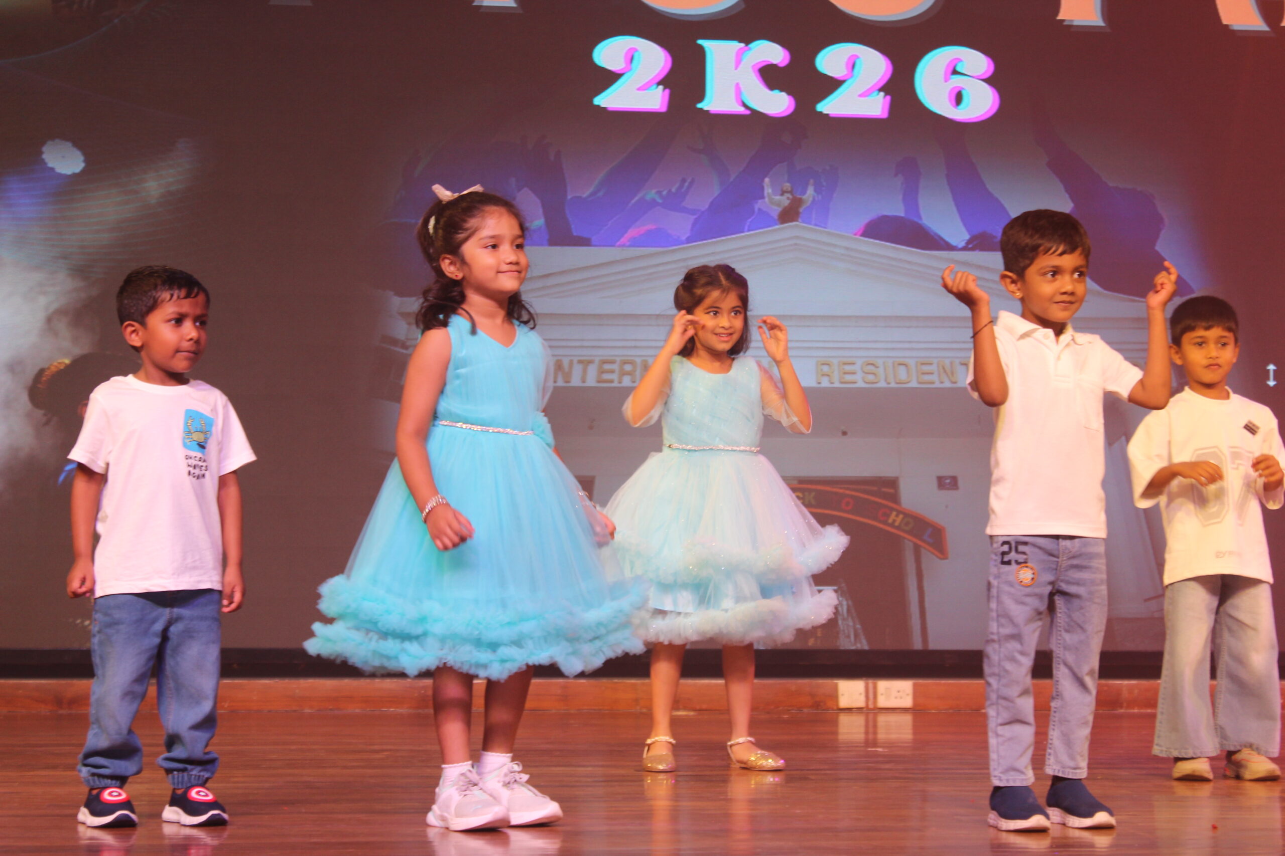 Students and staff performing during Novato Fiesta 2K25 Freshers' Day celebration at De Paul International Residential School, Mysuru.