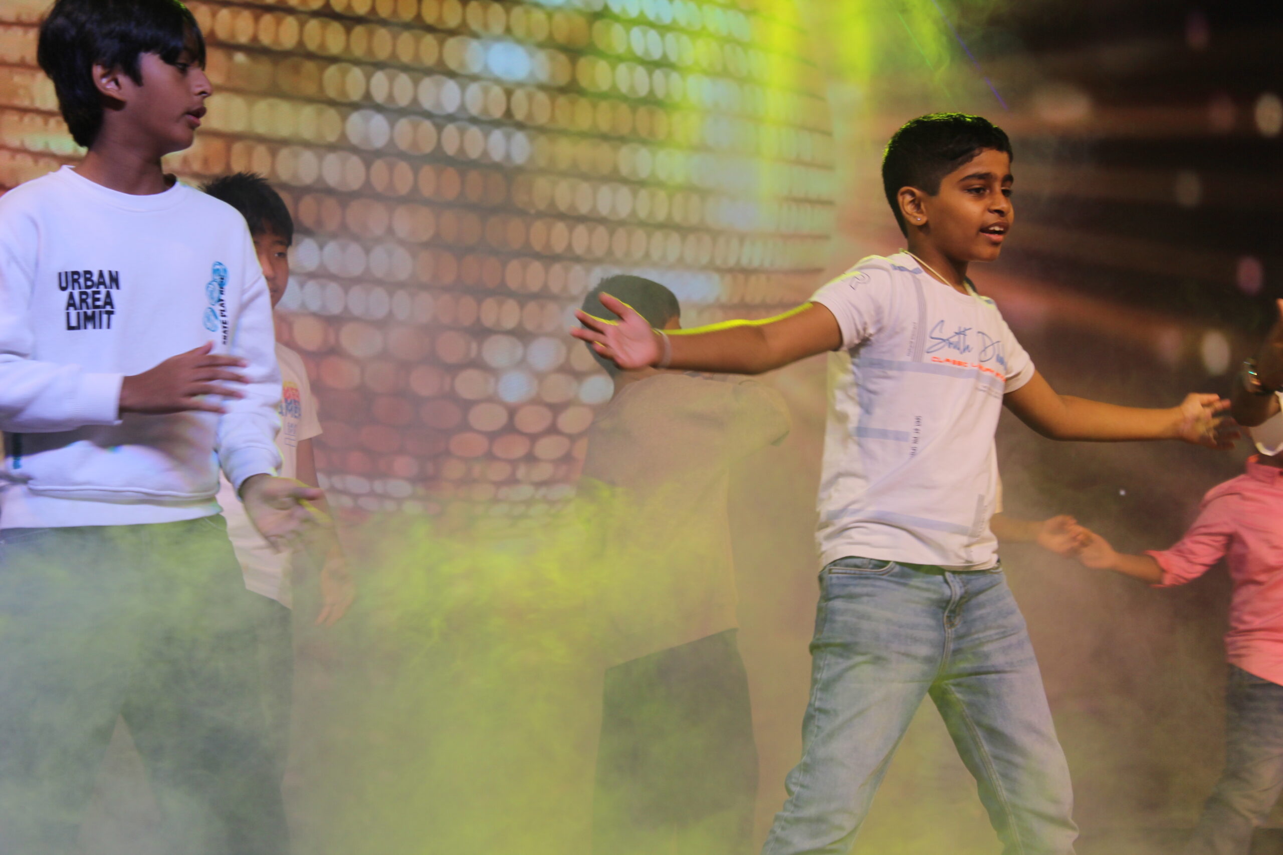 Students and staff performing during Novato Fiesta 2K25 Freshers' Day celebration at De Paul International Residential School, Mysuru.