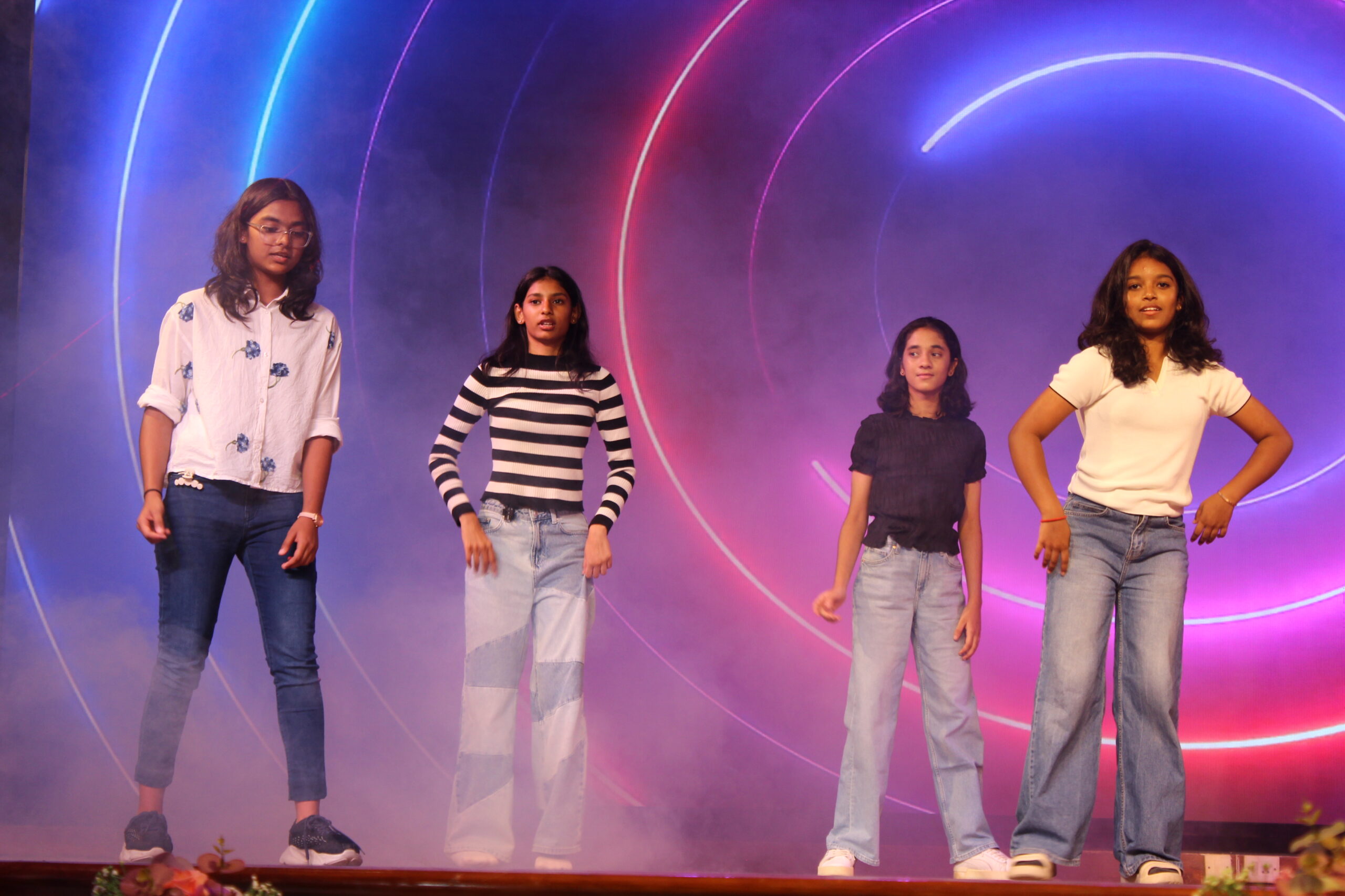 Students and staff performing during Novato Fiesta 2K25 Freshers' Day celebration at De Paul International Residential School, Mysuru.