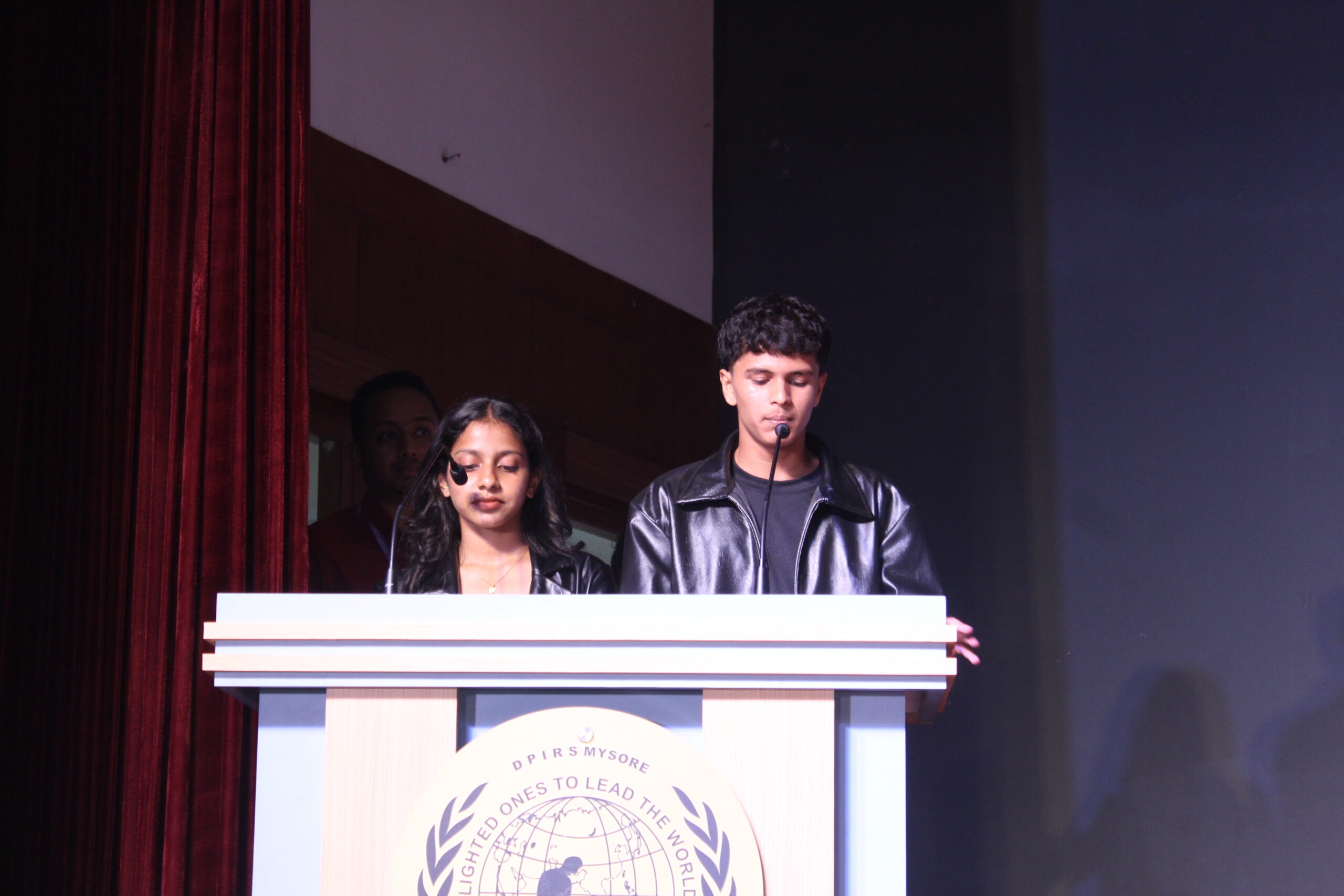 Students and staff performing during Novato Fiesta 2K25 Freshers' Day celebration at De Paul International Residential School, Mysuru.